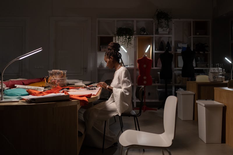 Illustration 1: A creative studio desk with multiple screens and reference material